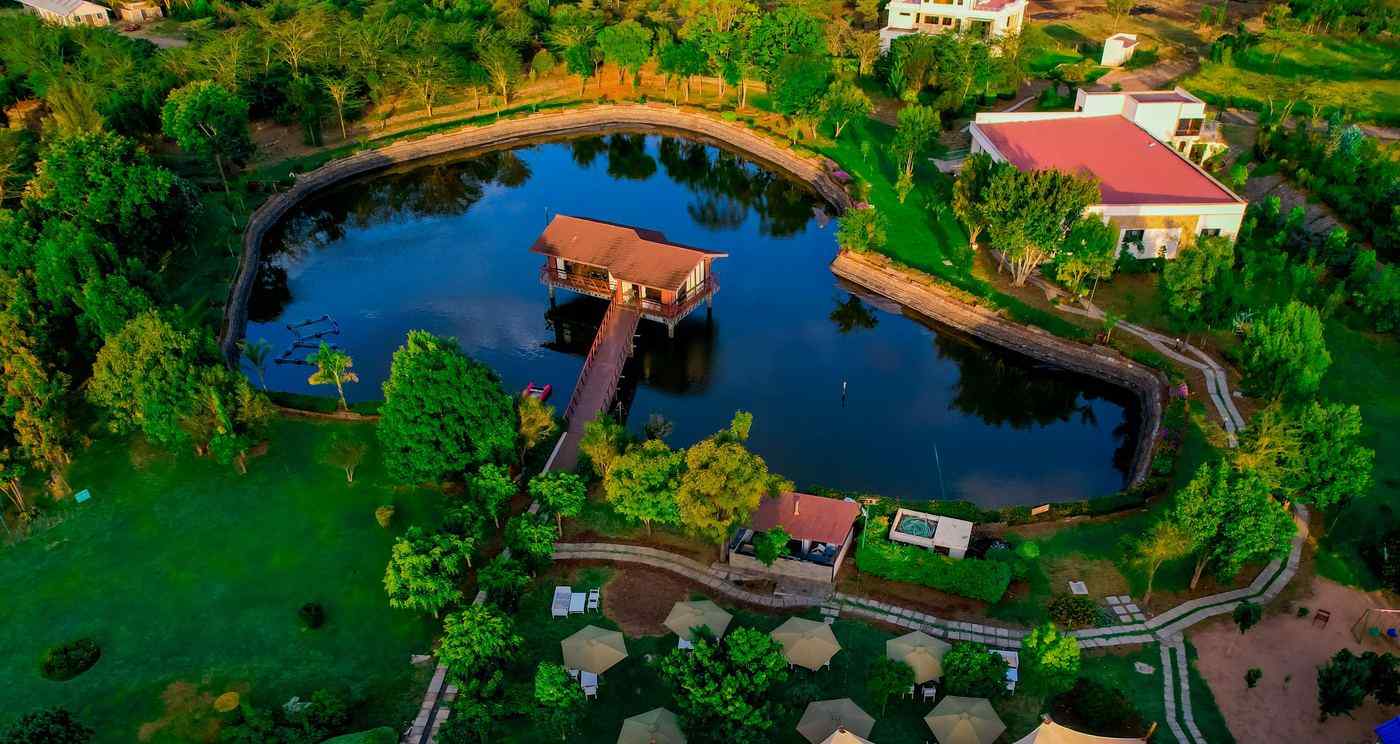 Aerial view of a pond and landscaped resort grounds at Sarova Maiyan Nanyuki