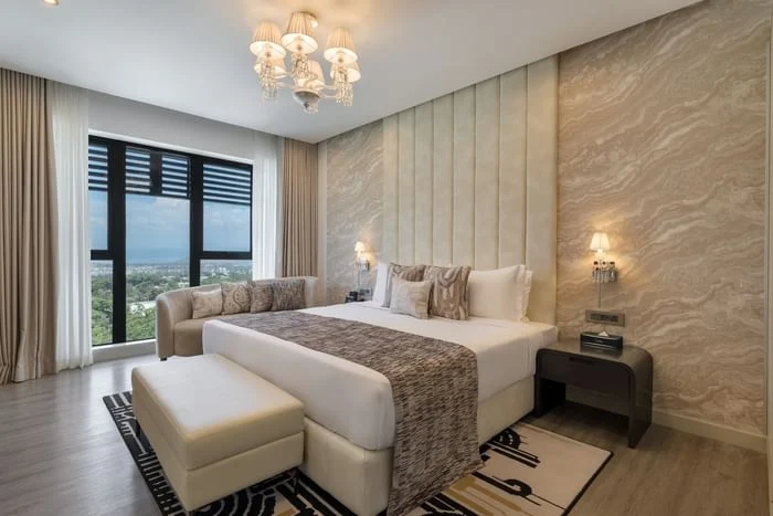 Guest room with twin beds and a garden-facing window at The Encore Hotel