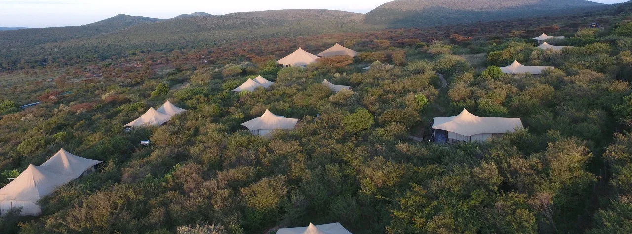 Tented camp set among trees and hills at Emayian Luxury Camp