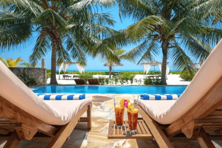 Dining tables facing a palm-lined beach in Zanzibar