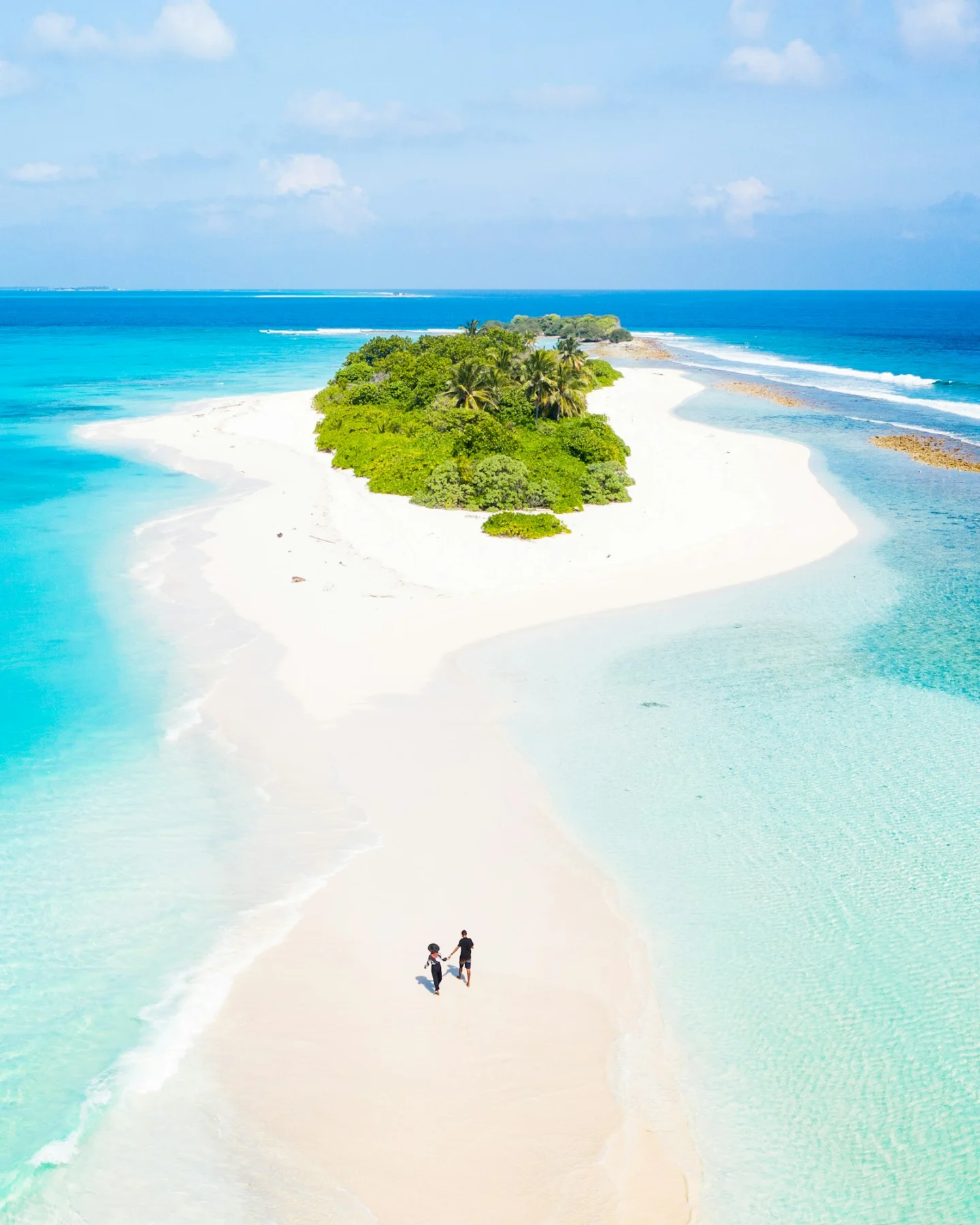 White-sand island surrounded by turquoise water in the Maldives