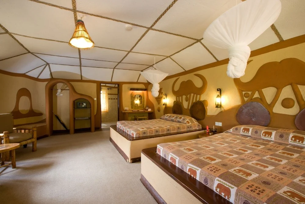 Twin beds and safari-themed interiors at Amboseli Sopa Lodge