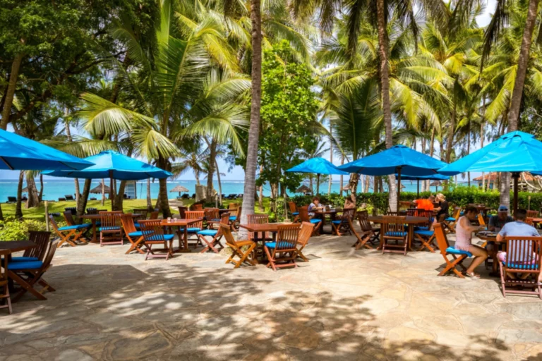 Palm-shaded beach seating at Diani Sea Resort